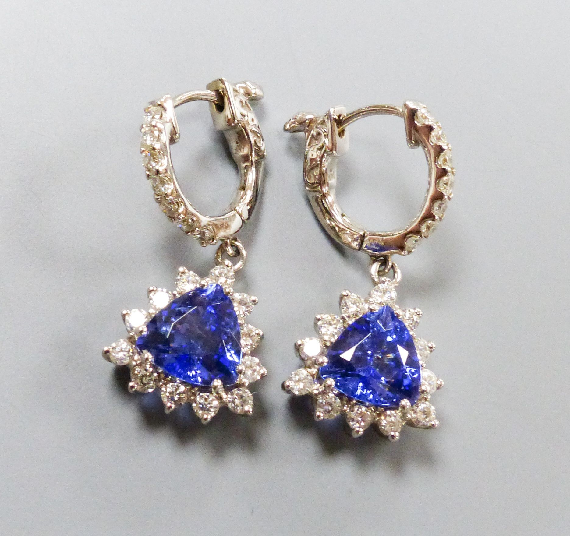 A modern pair of 14k white metal trillion cut tanzanite and diamond chip set cluster drop earrings, overall 26mm, gross weight 5.9 grams